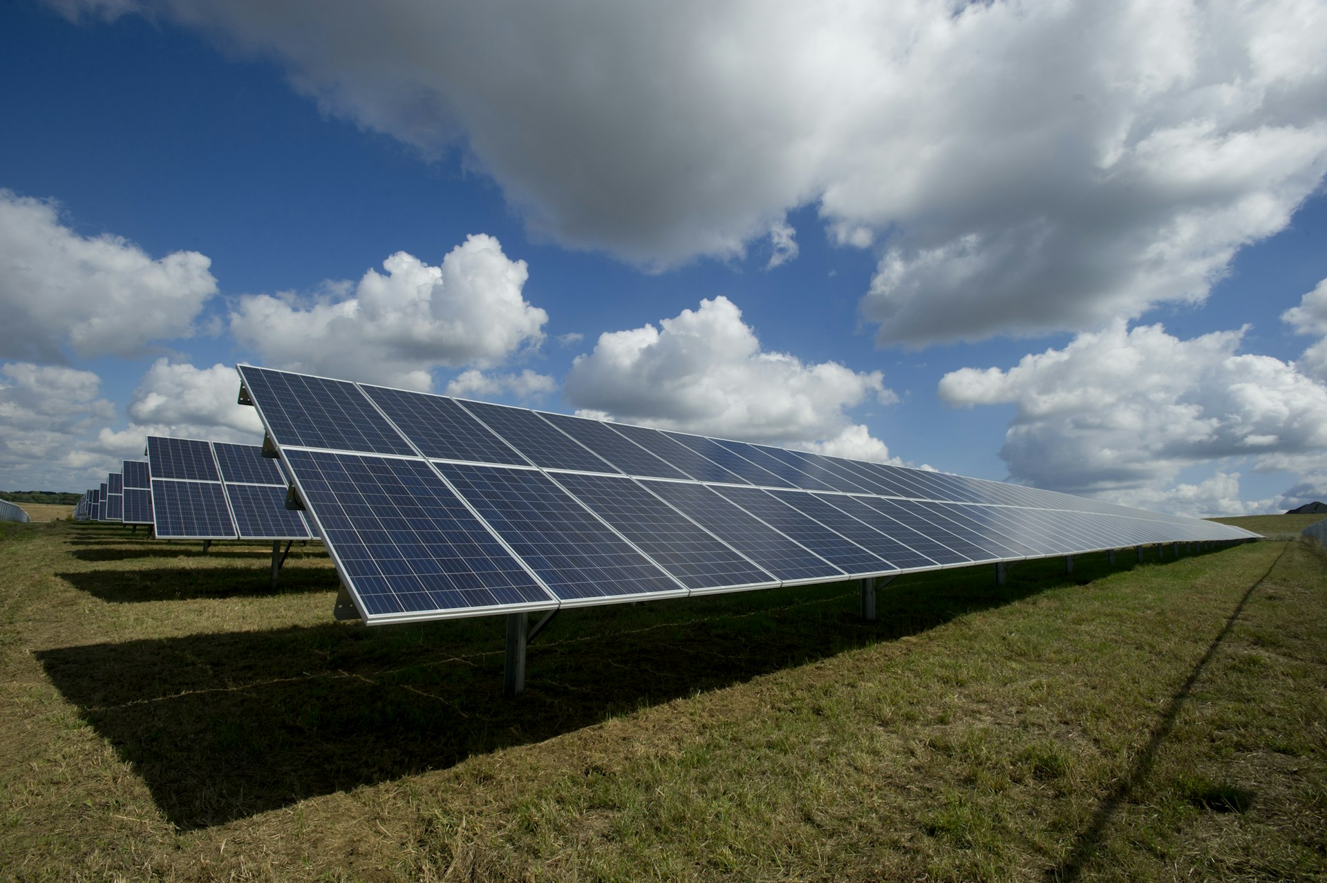 Clean solar panels on a residential roof under blue sky